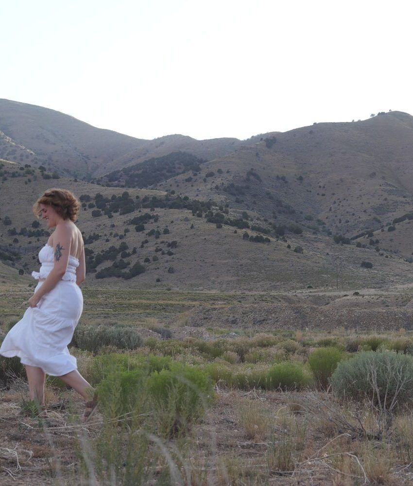 girl with white skirt running through a field