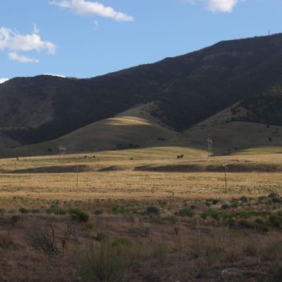 mountains with blue sky and grassy field