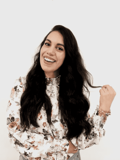Lizbeth, a past client of Sarah's posing. She has black long hair and a floral top on.